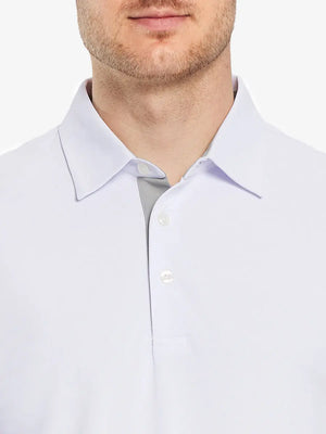 Model showcasing the white long sleeve pique polo, emphasizing its clean design and modern style.