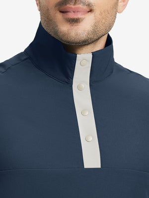 Close-up from nose to chest, highlighting buttoned collar and textured fabric of the navy pullover.