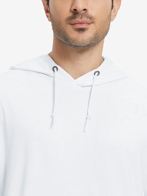 Close-up from nose to chest, showing soft heather texture and collar detail of the white hoodie.