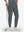 Front lower body shot of model wearing dark grey flat front golf joggers pants with belt loops