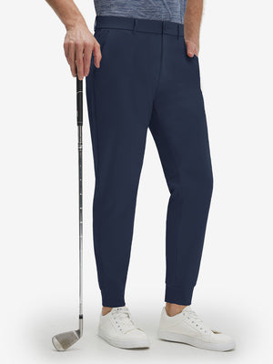 Front lower body shot of model wearing navy flat front golf joggers pants with belt loops