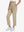 Front lower-body view of model with right hand in pocket wearing Khaki Women's 7/8 Ankle Golf Track Pants.