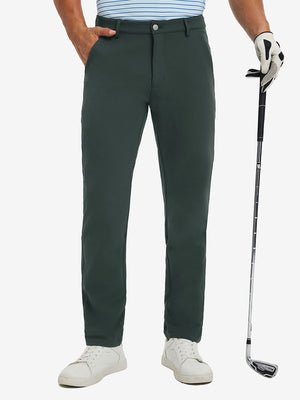 Lightweight moisture wicking dress pants in dark green, front lower-body with model leaning on golf club.