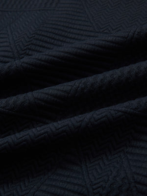 Close-up of fabric on textured insulated winter jacket, showing texture and finish in navy