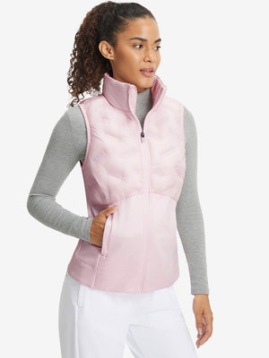 Front upper body of model wearing women's lightweight slim-fit puffer vest, sleek fit in light pink