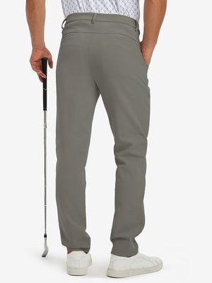 Back lower-body view of lightweight moisture wicking dress pants, model with golf club in dark khaki.