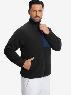Model wearing the reversible fleece jacket with 5 pockets in black, casually posing with one hand in the pocket for a stylish, practical look.