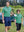 Father resting hand on son's shoulder in Cooling stripe golf shirts, warm green stripe moment