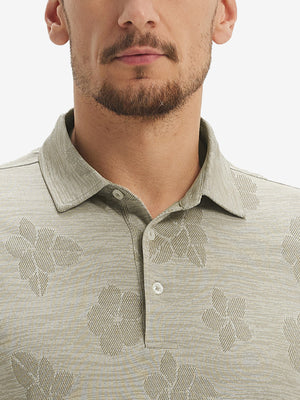 Front view from nose to chest of model wearing kakhi flower breathable jacquard pattern 3-button golf polo