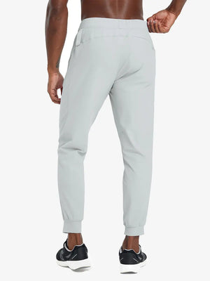 Back lower body view of model wearing GLACIER GREY Performance Tapered Sports Joggers