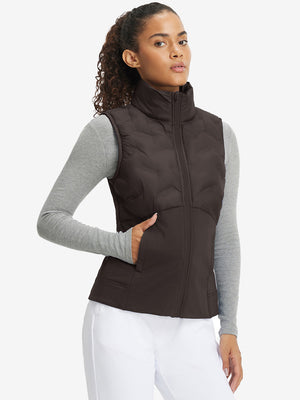 Front upper body of model wearing women's lightweight slim-fit puffer vest, sleek fit in coffee brown