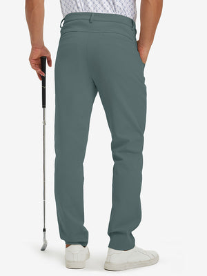 Back lower-body view of lightweight moisture wicking dress pants, model with golf club in dark dusty blue.