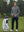 Model holding golf club beside golf bag in classic heather pullover hoodies with 2 pocket, grey melange