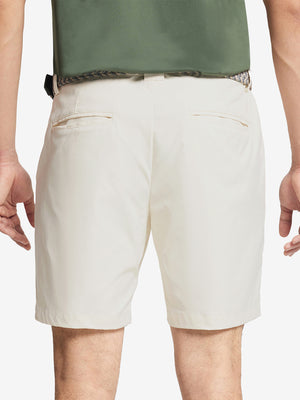 Back waist to knee view of beige water resistant golf 7 inch shorts, flexible performance fit.
