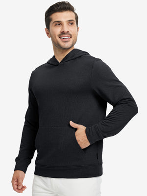 Model front view with one hand in side pocket wearing warm fleece golf hoodies pullover  black.