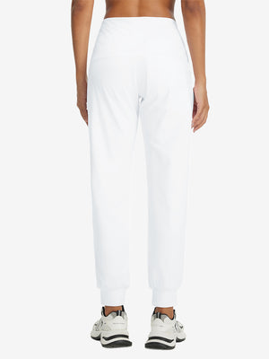 Model wearing women's stretch fleece lined water resistant joggers in white, showing the back lower body view.