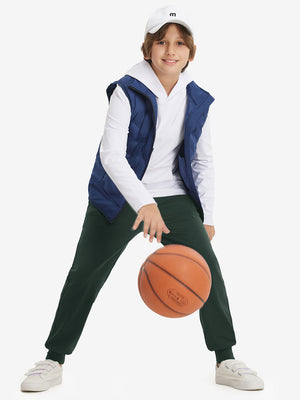Full-body shot of model wearing forest green fleece stretch water resistant boys joggers while playing basketball.