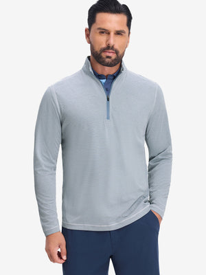 Front upper body shot of model wearing white light blue grid featherweight midlayer quarter zip pullover