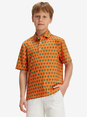 Front half-body of boy in orange cactus performance print boys golf polo