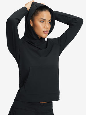 Model holding hoodie cap with both hands, wearing women's lightweight hoodies pullover in black.