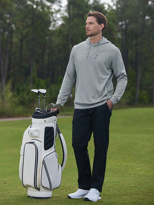 Full body model on golf course wearing classic heather pullover hoodies with 2 pocket, lunar rock melange