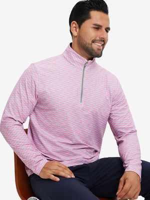 Model seated on chair, wearing full print quarter zip pullover in pink small fish, casual upper body view.