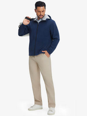 Full-body shot of model holding a golf bag while wearing light khaki thermal water repellent fleece dress pants