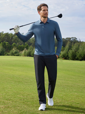 Model in blue long sleeve solid jersey polo holding a golf club outdoors, full-body shot