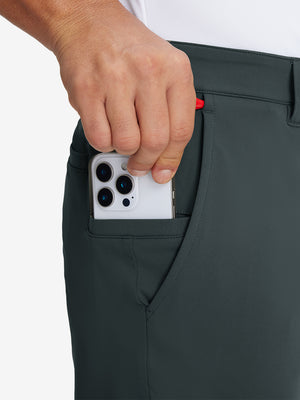 Hand placing an iPhone into pocket of soft lightweight casual golf pants with 5 pockets in dark grey.
