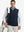Model carrying golf bag, styled in navy print collar quarter zip golf vest, relaxed sporty fit.