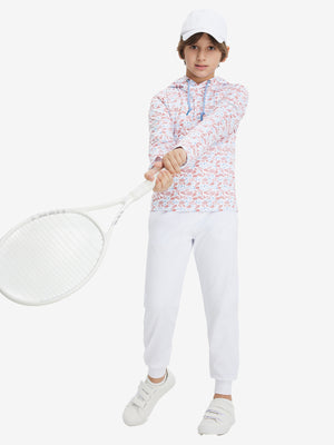 A full-body shot of a model wearing a youth full print stylish hoodie pullover in white pizza, playing tennis.