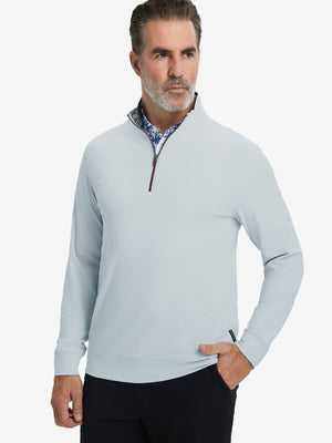 Front upper body view of model wearing lightweight golf quarter zip pullover in misty grey, relaxed fit.
