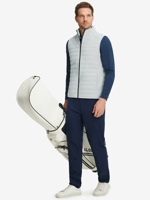 Model wearing Lightweight Water Resistant Puffer Vest in light grey heather, holding golf club