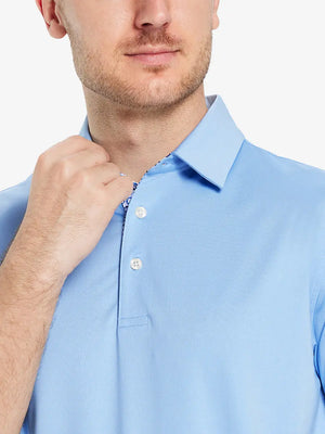 Male model wearing the Light Blue Everyday Classic Solid Polo, front view from nose to chest