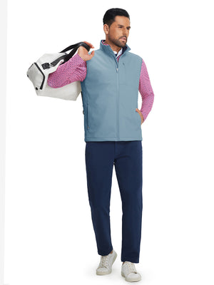 Full-body shot of model holding golf bag while wearing sleeveless softshell fleece outdoor vests with 6 pockets in misty blue