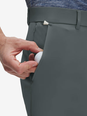 Detail view of front pocket on dark grey flat front golf joggers pants with belt loops