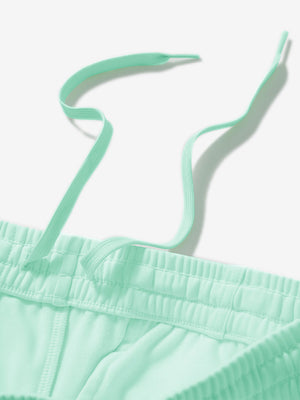 Close-up of the waistband with drawstring detail of turquoise fleece stretch water resistant boys joggers.