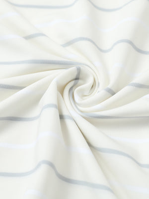 Close-up of beige stripe stylish stripe jersey golf polo fabric showing smooth texture and breathable knit.