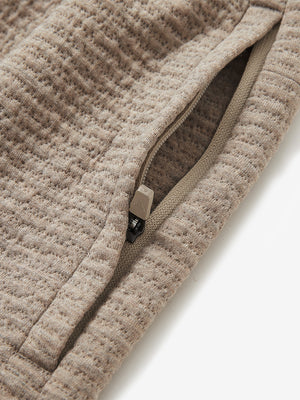 Detail of zipper pocket on soft sweatpants with 4 zipper pockets in light brown heather