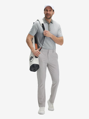 Full front: model in grey white stripe upgraded two-tone striped quick dry polo shirt carrying golf bag.