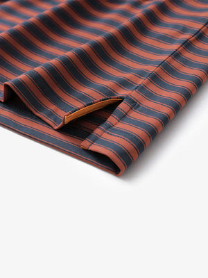 Close-up of the hem slit on the Rusty Red Navy Yarn Dyed Stripe Polo – a subtle touch of functionality