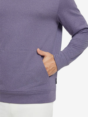 Close-up of model with both hands in pockets wearing warm fleece golf hoodies pullover purple.