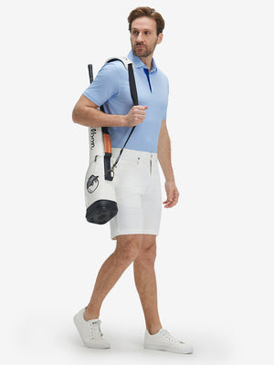 Full-body shot of model carring a golf bag in sky blue flower performance quick dry print golf polos