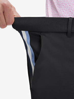 Detail view of elastic waistband on black breathable casual slacks with 4 pockets