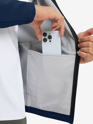 Hand placing an iPhone into pocket of water-resistant heat-tech softshell winter jacket with hood.