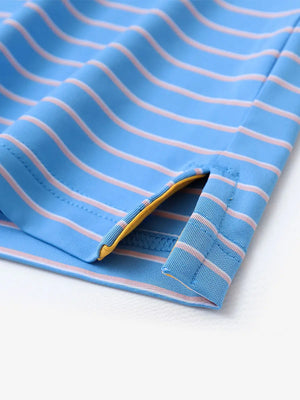 Hem slit detail of SKY BLUE/PINK STRIPE Youth Performance Golf Polo highlighting stitching and finish.