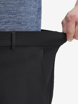Detail view of elastic waistband on black flat front golf joggers pants with belt loops