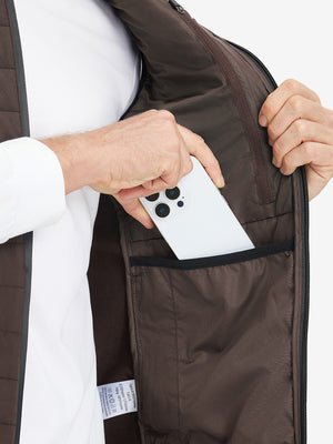 Inner pocket detail of Lightweight Water Resistant Puffer Vest in coffee brown, holding smartphone