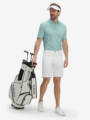 Full-body front view of model wearing the green lucky clover 4 way stretch print collared polo shirt, showing the complete outfit