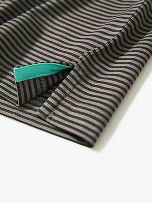 Close-up detail of side hem slit on Cooling Stripe Golf Shirt in BLACK STRIPE, emphasizing comfort and finish